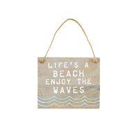 The Life’s A Beach Quote Plaque is a wooden sign with rope, featuring the phrase “Life’s a beach, enjoy the waves” and blue wave designs at the bottom.